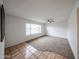 Bright living room featuring plush carpet, a ceiling fan, neutral walls, and large window at 4530 W Larkspur Dr, Glendale, AZ 85304