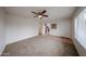 Bright living room featuring plush carpet, a ceiling fan, neutral walls, and tile entryway at 4530 W Larkspur Dr, Glendale, AZ 85304