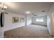 Spacious living room with carpet flooring, ceiling fan, and decorative wall art at 4530 W Larkspur Dr, Glendale, AZ 85304