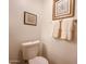 Toilet with framed art and towel at 4530 W Larkspur Dr, Glendale, AZ 85304
