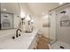 Modern bathroom features double sinks, black hardware, sleek mirrors, and a glass-enclosed shower at 4538 E Shomi St, Phoenix, AZ 85044