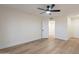 Bright bedroom featuring a ceiling fan, light wood floors and a white door at 4538 E Shomi St, Phoenix, AZ 85044