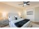 Bedroom with a ceiling fan, neutral walls, and a cozy bed with decorative pillows and throw at 4538 E Shomi St, Phoenix, AZ 85044