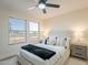 Bright bedroom features a ceiling fan, neutral walls, and a cozy bed with decorative pillows and throw at 4538 E Shomi St, Phoenix, AZ 85044