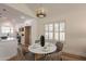 Bright dining area with modern light fixture next to the kitchen and shuttered window at 4538 E Shomi St, Phoenix, AZ 85044