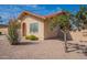 View of the side of a single-story home with a red tile roof, with desert landscaping and a tree at 4538 E Shomi St, Phoenix, AZ 85044