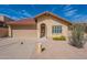 Single-story home with a red tile roof and desert landscaping, including cacti and yellow flowers at 4538 E Shomi St, Phoenix, AZ 85044