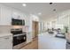 Well-equipped kitchen featuring stainless steel appliances, an island with seating, and open concept design at 4538 E Shomi St, Phoenix, AZ 85044