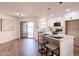 Open kitchen featuring an island, white cabinets and countertops, with sliding glass door to the backyard at 4538 E Shomi St, Phoenix, AZ 85044