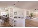 Bright, open-concept kitchen featuring white cabinets, large island with seating, and seamlessly connects to dining area at 4538 E Shomi St, Phoenix, AZ 85044