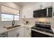 Bright kitchen with stainless steel appliances, white cabinetry, quartz counters and a view of the lake at 4538 E Shomi St, Phoenix, AZ 85044