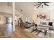 Open-concept living room with vaulted ceilings, light wood floors, neutral decor, and eat-in kitchen at 4538 E Shomi St, Phoenix, AZ 85044