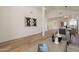 Open living space featuring wood floors and neutral decor, connecting to the dining area and kitchen at 4538 E Shomi St, Phoenix, AZ 85044