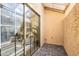 Private patio featuring brick flooring, stucco wall, and large glass sliding doors leading to the living area at 4538 E Shomi St, Phoenix, AZ 85044