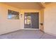 A covered patio with textured stucco walls, a window and a sliding glass door at 4538 E Shomi St, Phoenix, AZ 85044