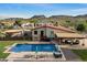 Spacious backyard with a sparkling pool, patio furniture, and lush landscaping against a mountain backdrop at 5044 W Electra Ln, Glendale, AZ 85310