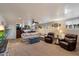 Expansive basement features a sectional sofa and rustic wooden bar, ideal for entertaining at 5044 W Electra Ln, Glendale, AZ 85310