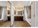 Beautiful bathroom featuring a dark vanity, tile flooring, and shower-tub combo at 5044 W Electra Ln, Glendale, AZ 85310