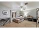 Bedroom featuring neutral-colored walls, a ceiling fan, and a large window at 5044 W Electra Ln, Glendale, AZ 85310