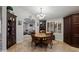 Dining room features tile floors, dark wood cabinetry and a view into the living room at 5044 W Electra Ln, Glendale, AZ 85310