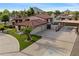 Aerial view of a home featuring a long driveway, garages, and well-maintained landscaping at 5044 W Electra Ln, Glendale, AZ 85310