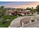 Beautiful home with mature landscaping, circular driveway, a water fountain, and gated entrance at 5044 W Electra Ln, Glendale, AZ 85310