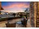 Charming front patio with brick accents and wicker chairs, perfect for enjoying the neighborhood view at 5044 W Electra Ln, Glendale, AZ 85310