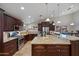 Spacious kitchen features an island, stainless steel appliances, and granite countertops at 5044 W Electra Ln, Glendale, AZ 85310