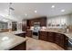 Kitchen featuring stainless steel appliances, granite countertops, and dark wood cabinetry at 5044 W Electra Ln, Glendale, AZ 85310