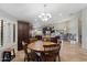 Eat-in kitchen features an island, granite countertops, tile floors and dark wood cabinetry at 5044 W Electra Ln, Glendale, AZ 85310