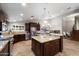 Spacious kitchen features an island, stainless steel appliances, and granite countertops at 5044 W Electra Ln, Glendale, AZ 85310