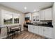 Bright kitchen features stainless appliances, lots of cabinets, and black countertops at 5044 W Electra Ln, Glendale, AZ 85310