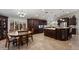 Kitchen features an island, granite countertops, tile floors, and dark wood cabinetry at 5044 W Electra Ln, Glendale, AZ 85310