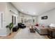 Bright living room featuring neutral decor, a gray couch and comfortable seating at 5044 W Electra Ln, Glendale, AZ 85310