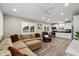 Open-concept living area with wood floors seamlessly transitions to the modern kitchen at 5044 W Electra Ln, Glendale, AZ 85310