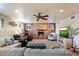 Relaxing living room with a brick fireplace, ceiling fan and comfortable seating at 5044 W Electra Ln, Glendale, AZ 85310