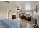 Large bedroom with fireplace, dresser, television and comfortable armchair at 5044 W Electra Ln, Glendale, AZ 85310