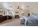 Comfortable bedroom with fireplace, a lounge chair, and natural light at 5044 W Electra Ln, Glendale, AZ 85310