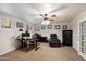 Office featuring a ceiling fan, desk, leather chair, and safe at 5044 W Electra Ln, Glendale, AZ 85310