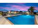 Beautiful backyard pool featuring lounge chairs, umbrellas, and an inviting outdoor space at 5044 W Electra Ln, Glendale, AZ 85310