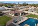 Aerial view featuring a pool, patio furniture, and well-maintained landscaping against a mountain backdrop at 5044 W Electra Ln, Glendale, AZ 85310