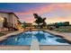 Inviting backyard oasis with sparkling pool, lounge chairs, and an outdoor kitchen perfect for entertaining at 5044 W Electra Ln, Glendale, AZ 85310