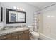 Bathroom with a granite countertop vanity, framed mirror, and a shower-tub combo at 540 N May -- # 2110, Mesa, AZ 85201