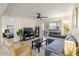 Bright living room with sliding door access, ceiling fan, and views to an adjacent bedroom at 540 N May -- # 2110, Mesa, AZ 85201