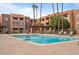 Outdoor pool area featuring lounge chairs, desert landscaping, and shade structures at 540 N May -- # 2110, Mesa, AZ 85201