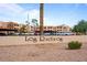 Entrance Signage for Los Racimos community surrounded by palm trees and landscaping at 540 N May -- # 2110, Mesa, AZ 85201