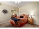 Cozy bedroom featuring a mirror closet door, a decorative bedspread, and wooden nightstands at 5445 E Mckellips Rd # 48, Mesa, AZ 85215