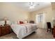 Bright bedroom featuring a queen-sized bed, soft carpet, and white curtains at 5445 E Mckellips Rd # 48, Mesa, AZ 85215