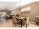 Cozy dining area featuring decorative wall plates and a stylish chandelier above the marble table at 5445 E Mckellips Rd # 48, Mesa, AZ 85215