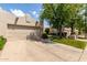 Inviting single-story home with a two-car garage, lush lawn, and desert landscaping at 5445 E Mckellips Rd # 48, Mesa, AZ 85215